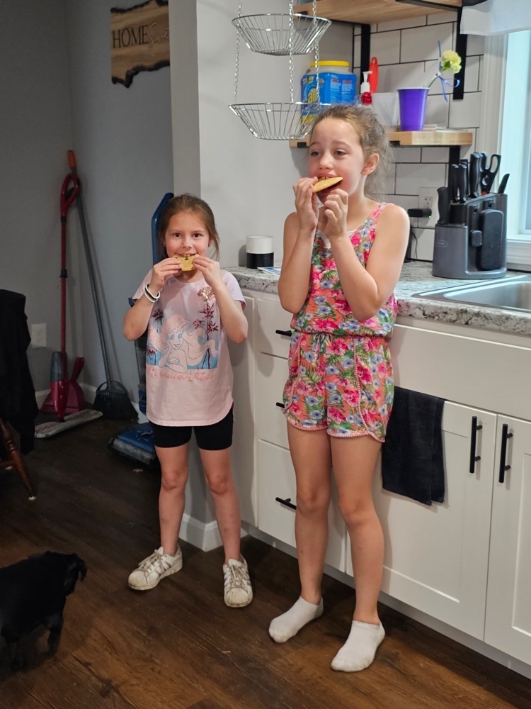 two girls eating cookies