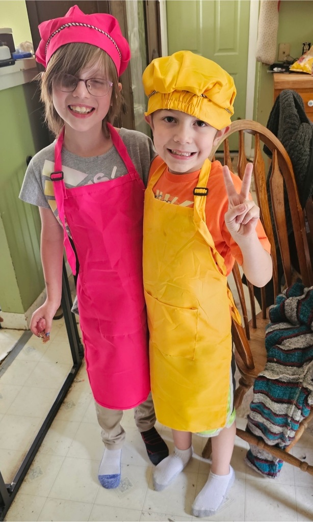 a boy and girl in aprons and chef hats